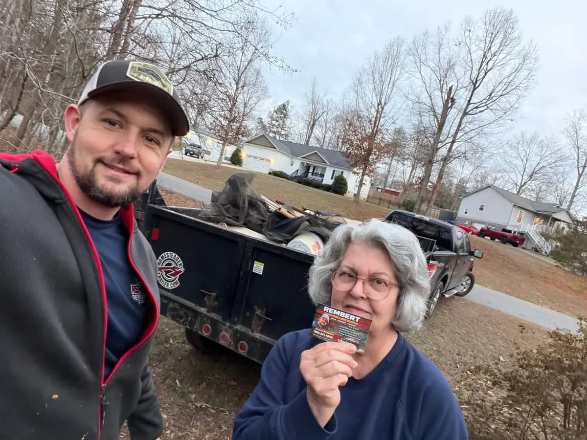 Rembert Demolition & Junk Removal with a customer after a completed job